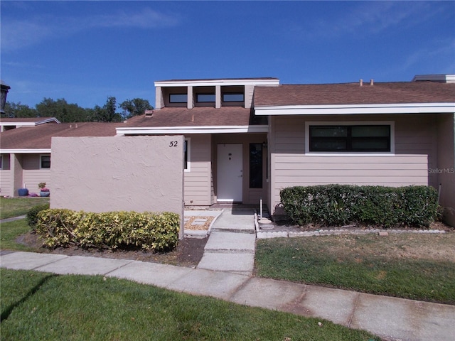 view of front of property with roof with shingles