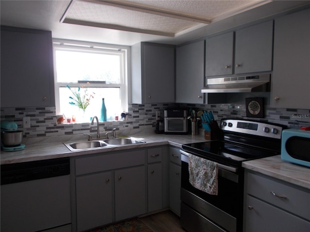kitchen featuring stainless steel electric stove, a sink, white dishwasher, light countertops, and under cabinet range hood