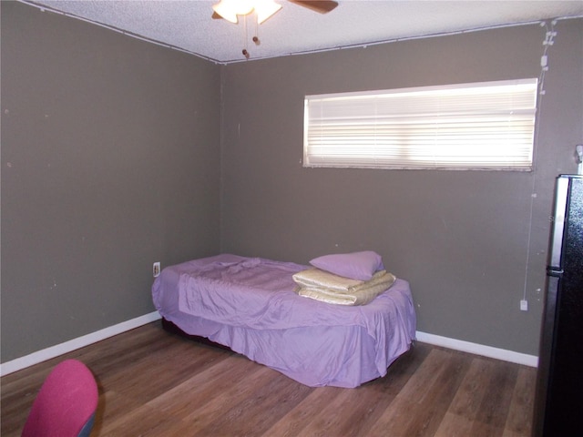 bedroom with wood finished floors, baseboards, and ceiling fan