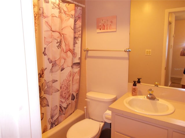 full bathroom featuring shower / bath combination with curtain, vanity, and toilet