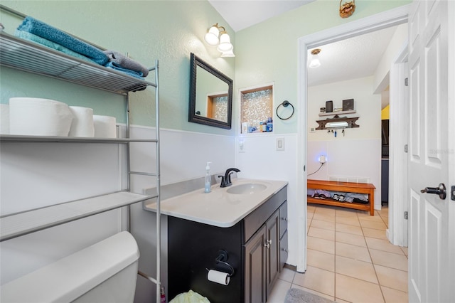 bathroom with vanity, tile patterned flooring, and toilet