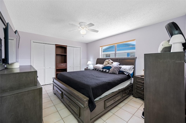 bedroom featuring light tile patterned floors, a textured ceiling, and ceiling fan
