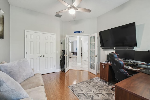 office area featuring a ceiling fan, visible vents, french doors, and light wood-style flooring