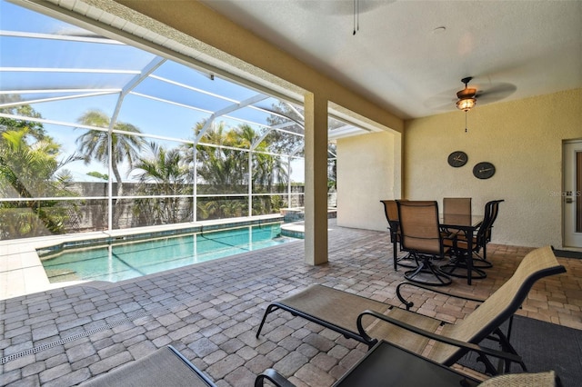 outdoor pool featuring ceiling fan, a patio area, and glass enclosure