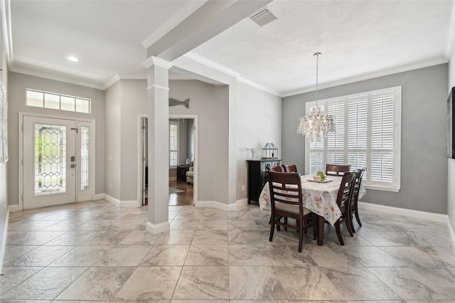 dining room with visible vents, crown molding, baseboards, an inviting chandelier, and ornate columns