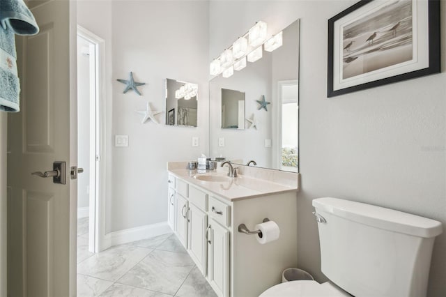 bathroom featuring vanity, marble finish floor, a notable chandelier, and toilet