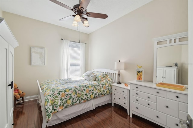 bedroom featuring dark wood-type flooring, baseboards, and ceiling fan
