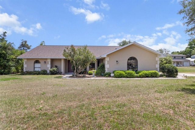 ranch-style house with stucco siding and a front yard