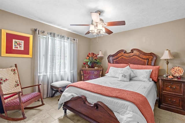 bedroom with stone finish flooring and a ceiling fan