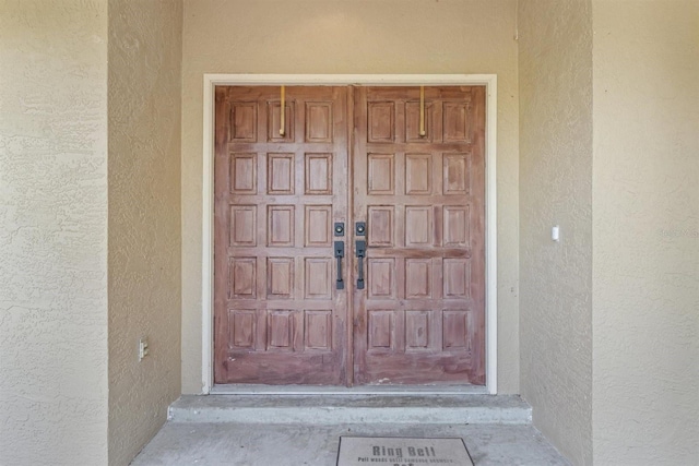 property entrance with stucco siding