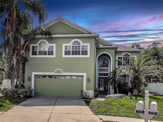 11102 Avery Oaks Dr, Tampa, FL 33625 - view of front of property with a garage, stucco siding, concrete driveway, and fence