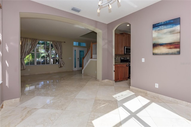 11102 Avery Oaks Dr, Tampa, FL 33625 - interior space featuring stairway, arched walkways, visible vents, and baseboards