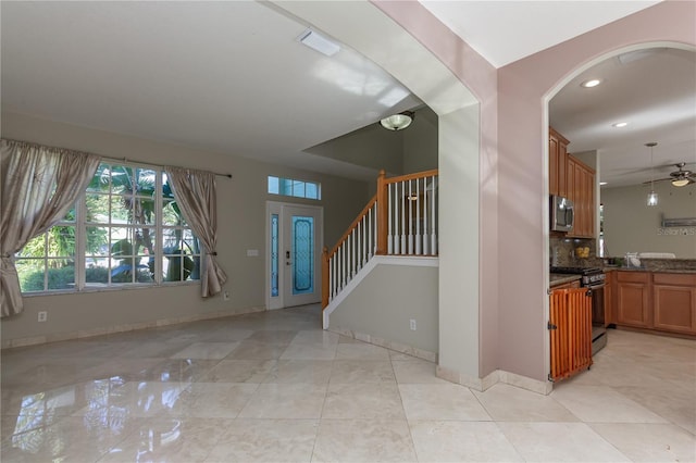 11102 Avery Oaks Dr, Tampa, FL 33625 - foyer entrance featuring stairs, ceiling fan, arched walkways, baseboards, and recessed lighting