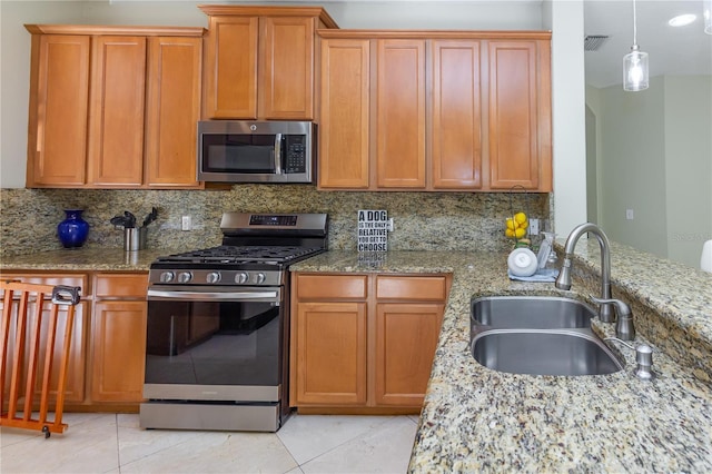11102 Avery Oaks Dr, Tampa, FL 33625 - kitchen with appliances with stainless steel finishes, light stone counters, and a sink