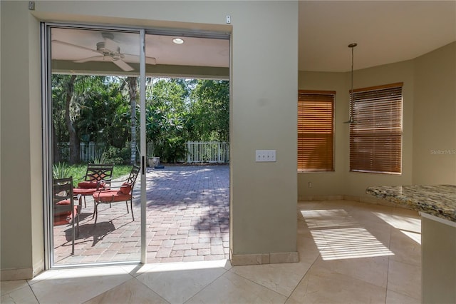 11102 Avery Oaks Dr, Tampa, FL 33625 - doorway to outside with baseboards and ceiling fan
