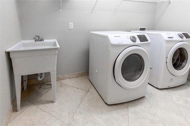 11102 Avery Oaks Dr, Tampa, FL 33625 - laundry room featuring baseboards, separate washer and dryer, and laundry area