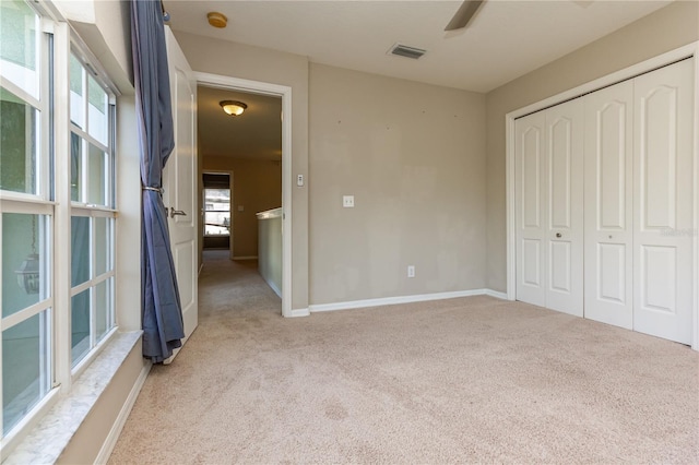 11102 Avery Oaks Dr, Tampa, FL 33625 - unfurnished bedroom with a ceiling fan, a closet, light colored carpet, baseboards, and visible vents