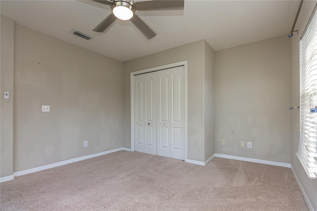 11102 Avery Oaks Dr, Tampa, FL 33625 - unfurnished bedroom with visible vents, a closet, carpet flooring, and multiple windows