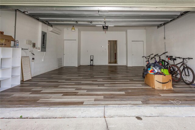 11102 Avery Oaks Dr, Tampa, FL 33625 - garage with electric panel, an AC wall unit, and a garage door opener