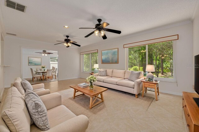 1144 Lanyard St, Palm Harbor, FL 34685 - living room featuring light tile patterned floors, crown molding, and visible vents