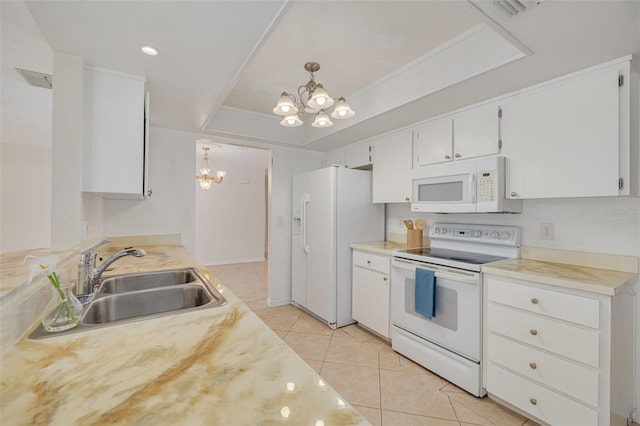 1144 Lanyard St, Palm Harbor, FL 34685 - kitchen with an inviting chandelier, white appliances, a raised ceiling, white cabinets, and a sink