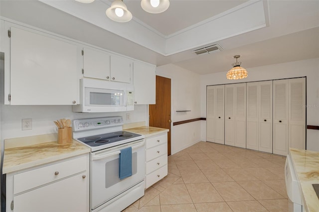 1144 Lanyard St, Palm Harbor, FL 34685 - kitchen with visible vents, light tile patterned flooring, white appliances, light countertops, and white cabinetry
