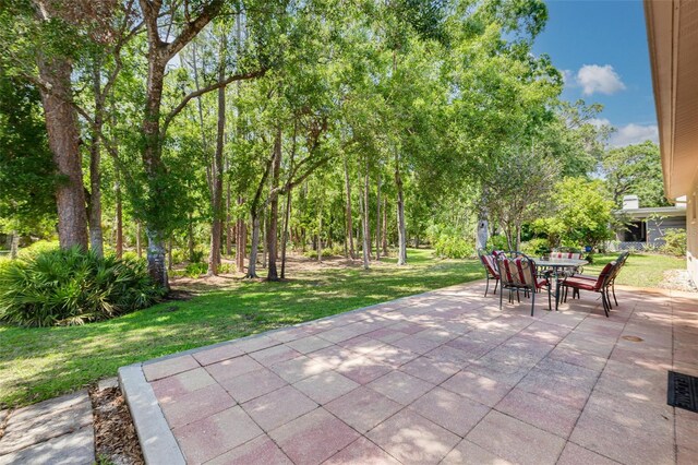 1144 Lanyard St, Palm Harbor, FL 34685 - view of patio with visible vents and outdoor dining area