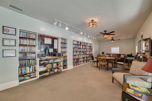 1144 Lanyard St, Palm Harbor, FL 34685 - interior space with visible vents, ceiling fan, a textured ceiling, rail lighting, and carpet