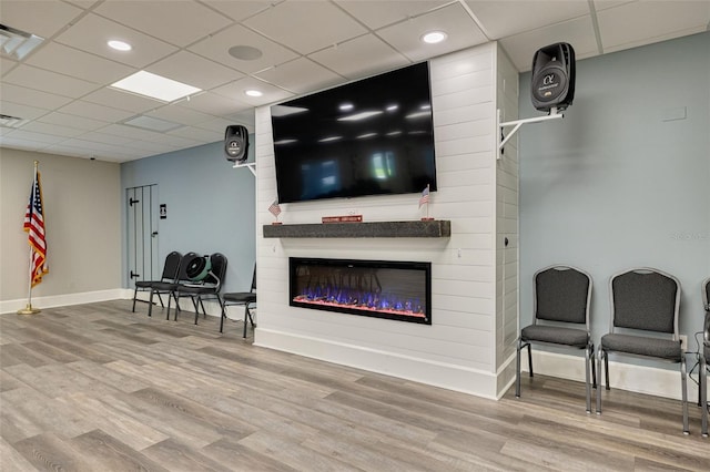 1144 Lanyard St, Palm Harbor, FL 34685 - living room with baseboards, a glass covered fireplace, a drop ceiling, and wood finished floors