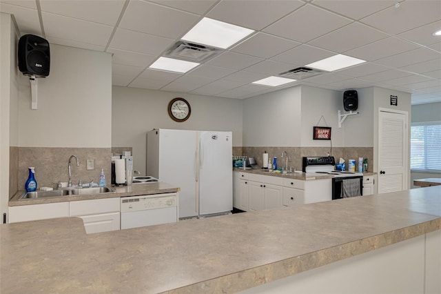 1144 Lanyard St, Palm Harbor, FL 34685 - kitchen featuring visible vents, a sink, white cabinetry, and white appliances