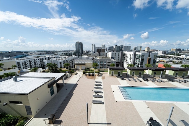 community pool featuring a city view and a patio area