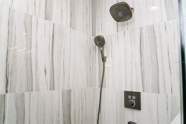 interior details featuring tiled shower