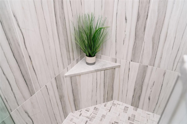 bathroom view of a marble finish shower