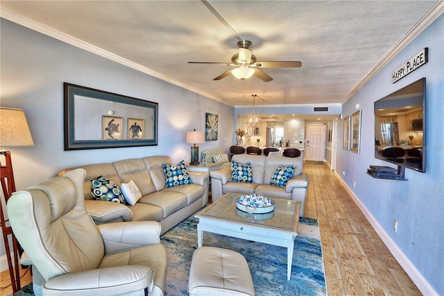 7480 Bayshore Dr Unit 402, Treasure Island, FL 33706 - living room with a ceiling fan, light wood-type flooring, crown molding, baseboards, and a textured ceiling