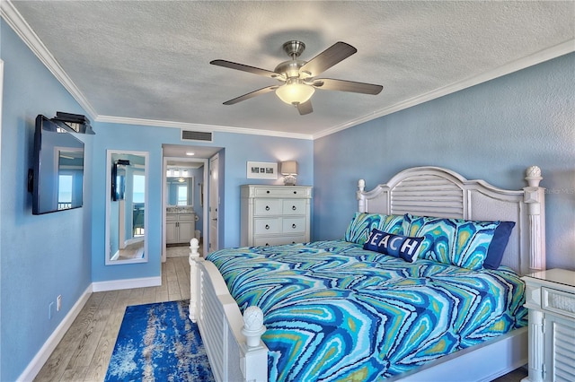 7480 Bayshore Dr Unit 402, Treasure Island, FL 33706 - bedroom featuring a textured ceiling, wood finished floors, ornamental molding, baseboards, and a ceiling fan