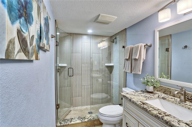 7480 Bayshore Dr Unit 402, Treasure Island, FL 33706 - full bathroom with toilet, a textured wall, a shower stall, vanity, and a textured ceiling