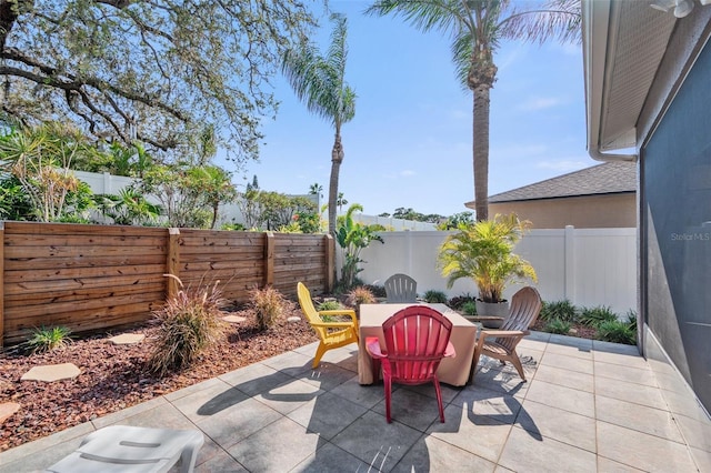 708 Sandy Hills Ave, Tarpon Springs, FL 34689 - fenced backyard with outdoor dining space and a patio area
