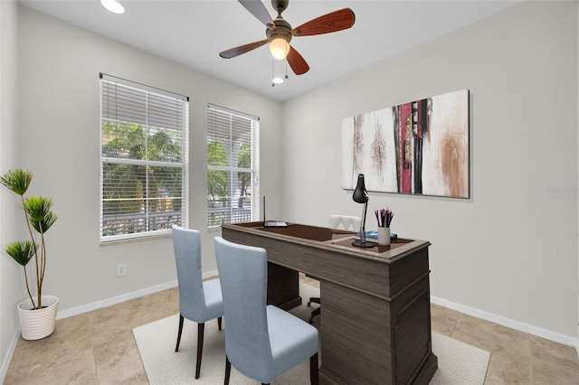 home office featuring light tile patterned floors, baseboards, and a ceiling fan