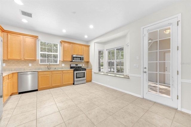 kitchen with visible vents, a sink, appliances with stainless steel finishes, and backsplash