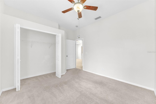unfurnished bedroom featuring carpet flooring, baseboards, visible vents, and a closet