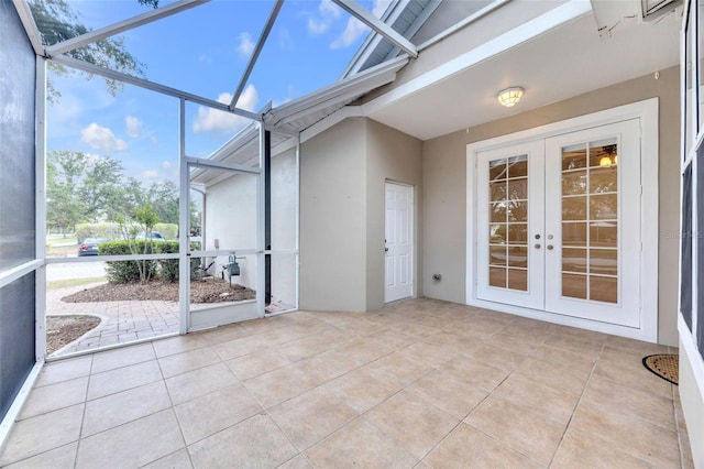 unfurnished sunroom with french doors