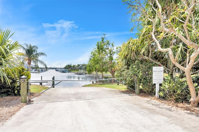 view of road with a water view and driveway