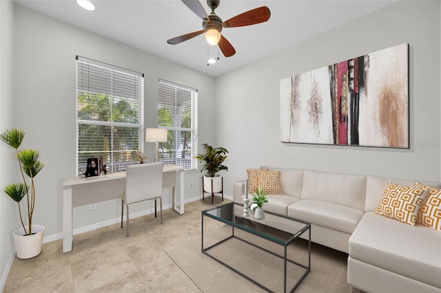 living area featuring baseboards, a ceiling fan, and recessed lighting