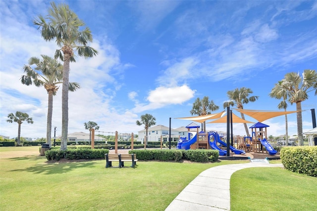 view of property's community featuring a lawn and playground community
