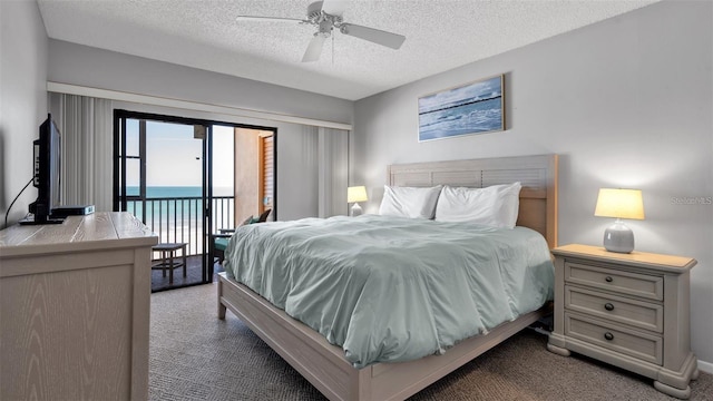 13720 Gulf Blvd Unit 305, Madeira Beach, FL 33708 - bedroom with dark colored carpet, a textured ceiling, ceiling fan, and access to exterior