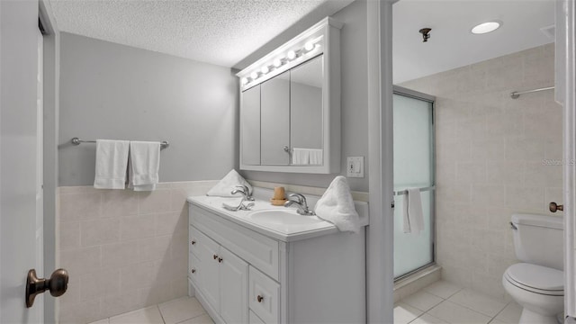 13720 Gulf Blvd Unit 305, Madeira Beach, FL 33708 - full bath featuring vanity, tile walls, a shower stall, and tile patterned floors