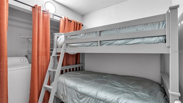 13720 Gulf Blvd Unit 305, Madeira Beach, FL 33708 - bedroom featuring washer / clothes dryer and a textured ceiling