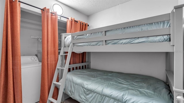 13720 Gulf Blvd Unit 305, Madeira Beach, FL 33708 - bedroom featuring washer / clothes dryer and a textured ceiling