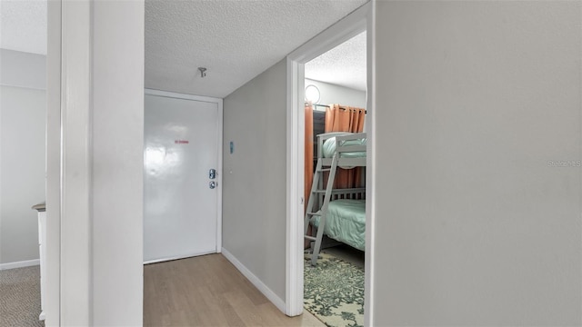 13720 Gulf Blvd Unit 305, Madeira Beach, FL 33708 - hall with baseboards, wood finished floors, and a textured ceiling