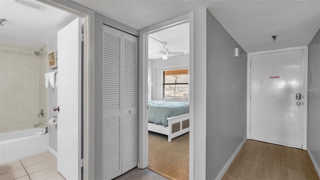 13720 Gulf Blvd Unit 305, Madeira Beach, FL 33708 - hall featuring a textured ceiling, visible vents, and baseboards